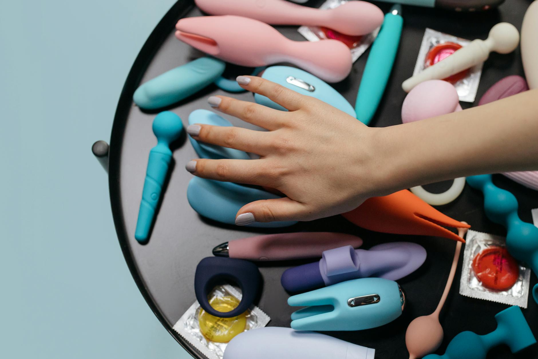 Array of colorful clitoral vibrators and sex toys displayed closely together